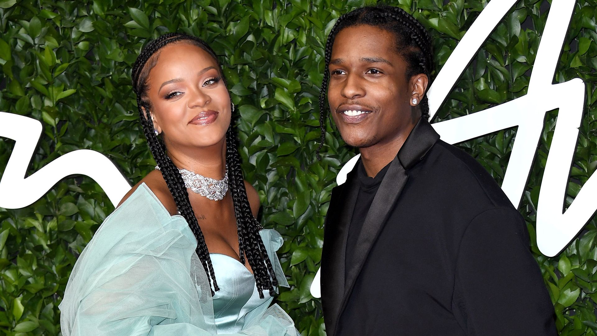 Rihanna and ASAP Rocky smiling at a red carpet event