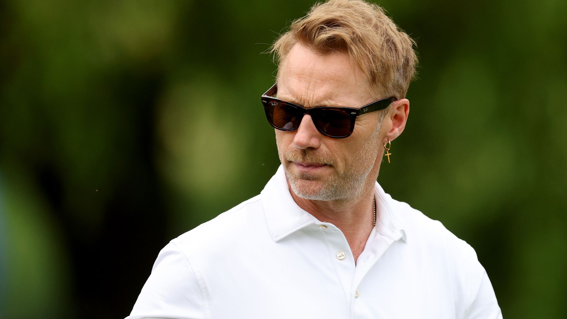 Ronan Keating serious in white top and glasses