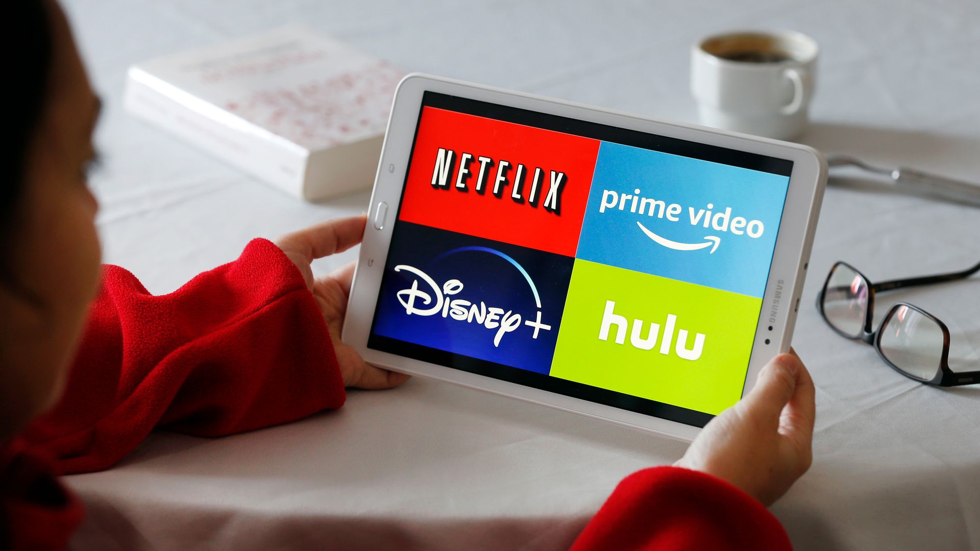In this photo illustration, the logos of media service providers, Netflix, Amazon Prime Video, Disney + and Hulu are displayed on the screen of a tablet on November 20, 2019 in Paris, France