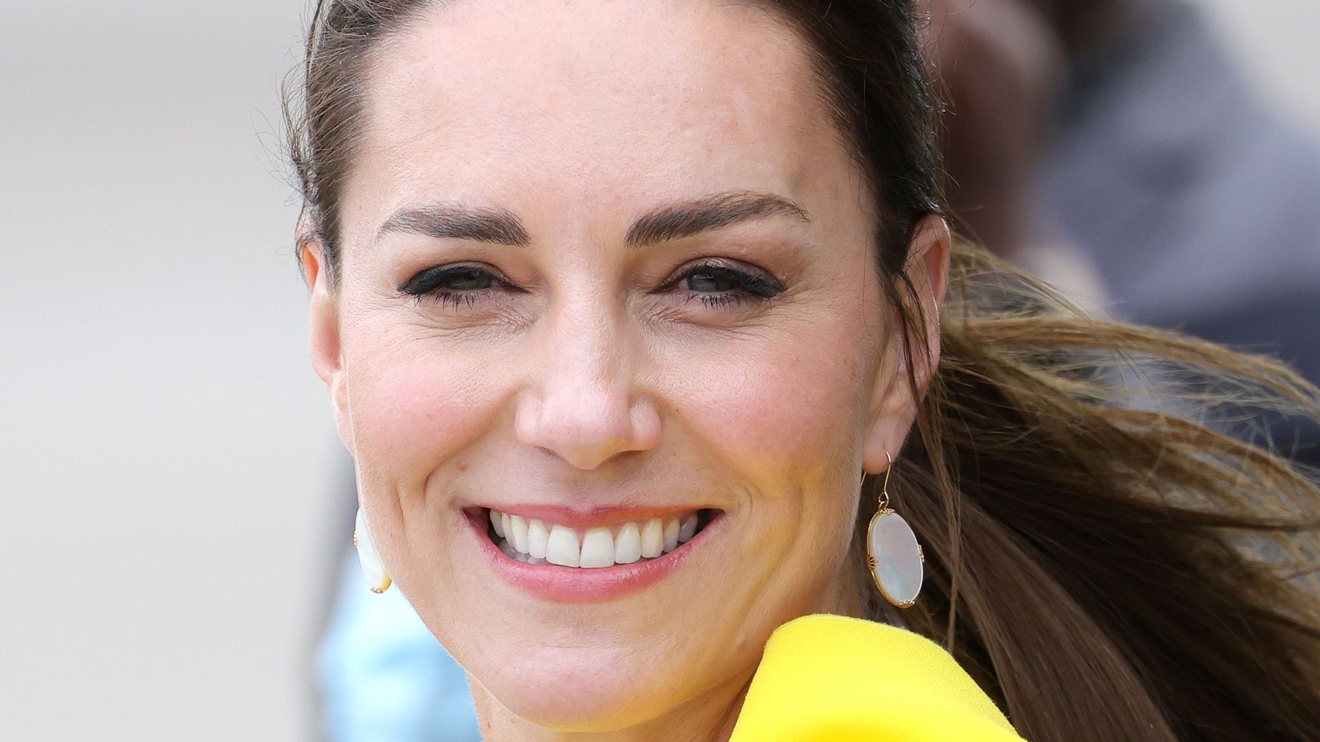Kate Middleton in yellow during official arrival at Norman Manley International Airport in Kingston