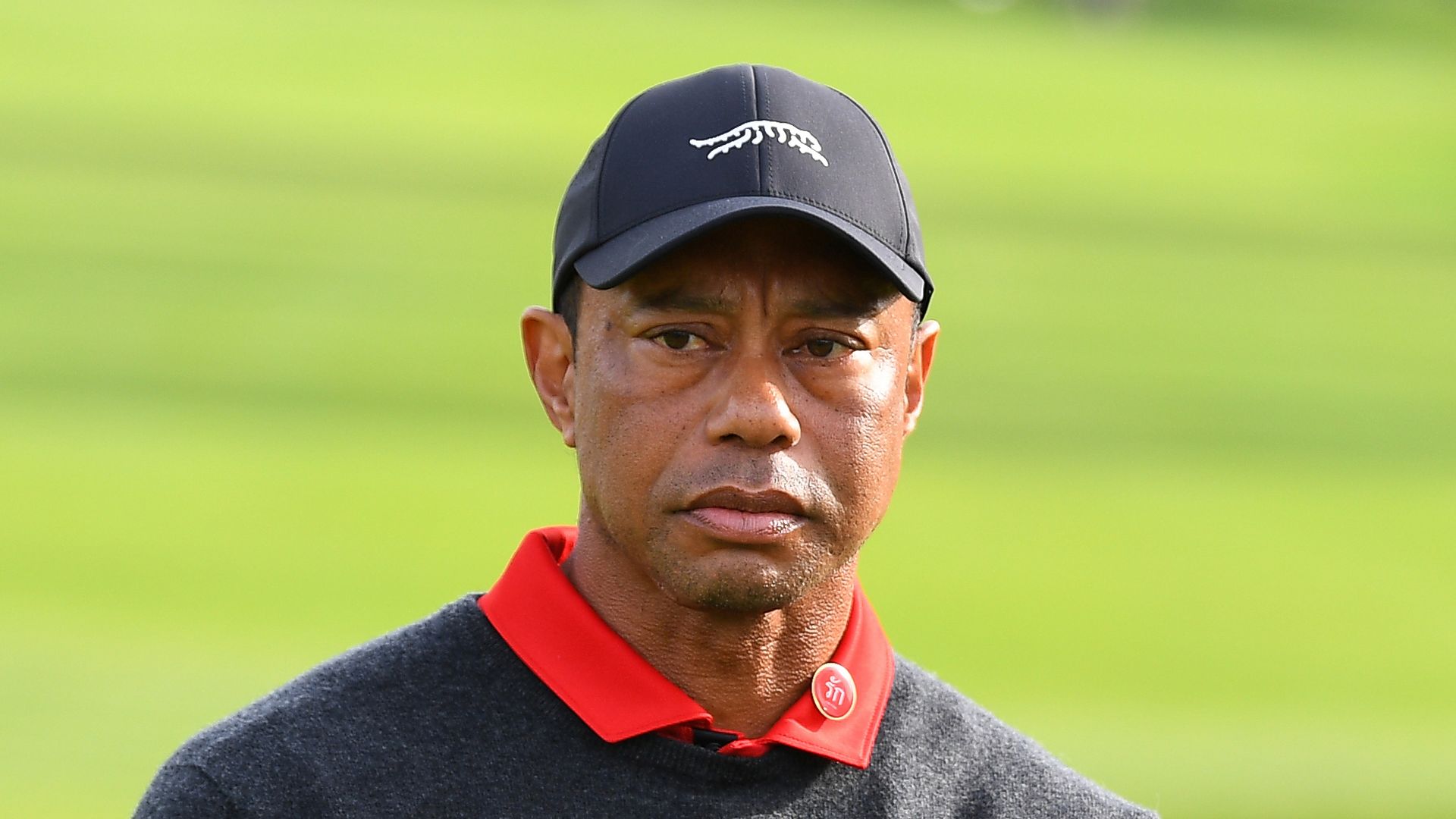 tiger woods arms crossed on golfing green
