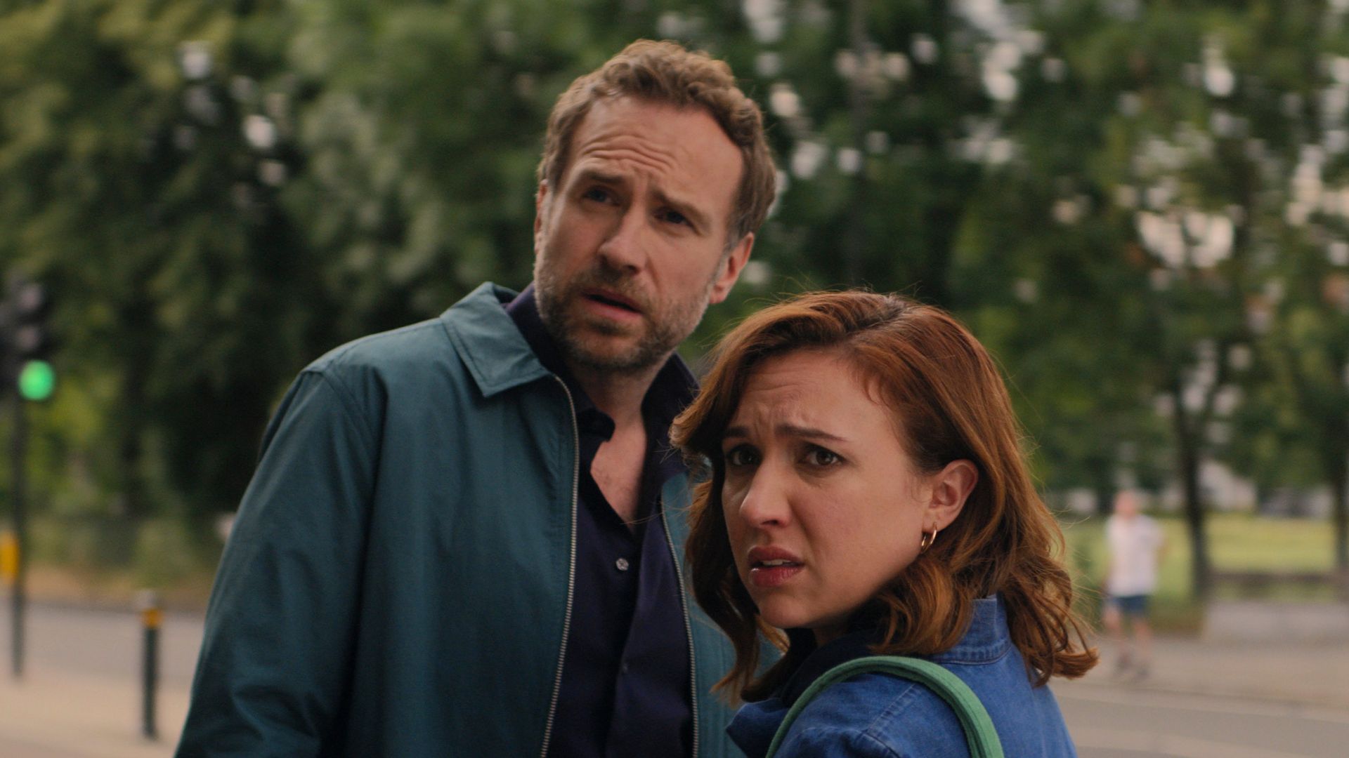 man and woman standing in street