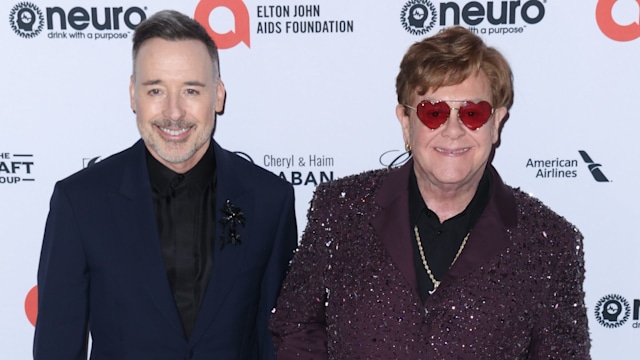 David Furnish standing with Elton John