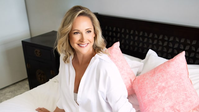 woman on a white bed in a night shirt 