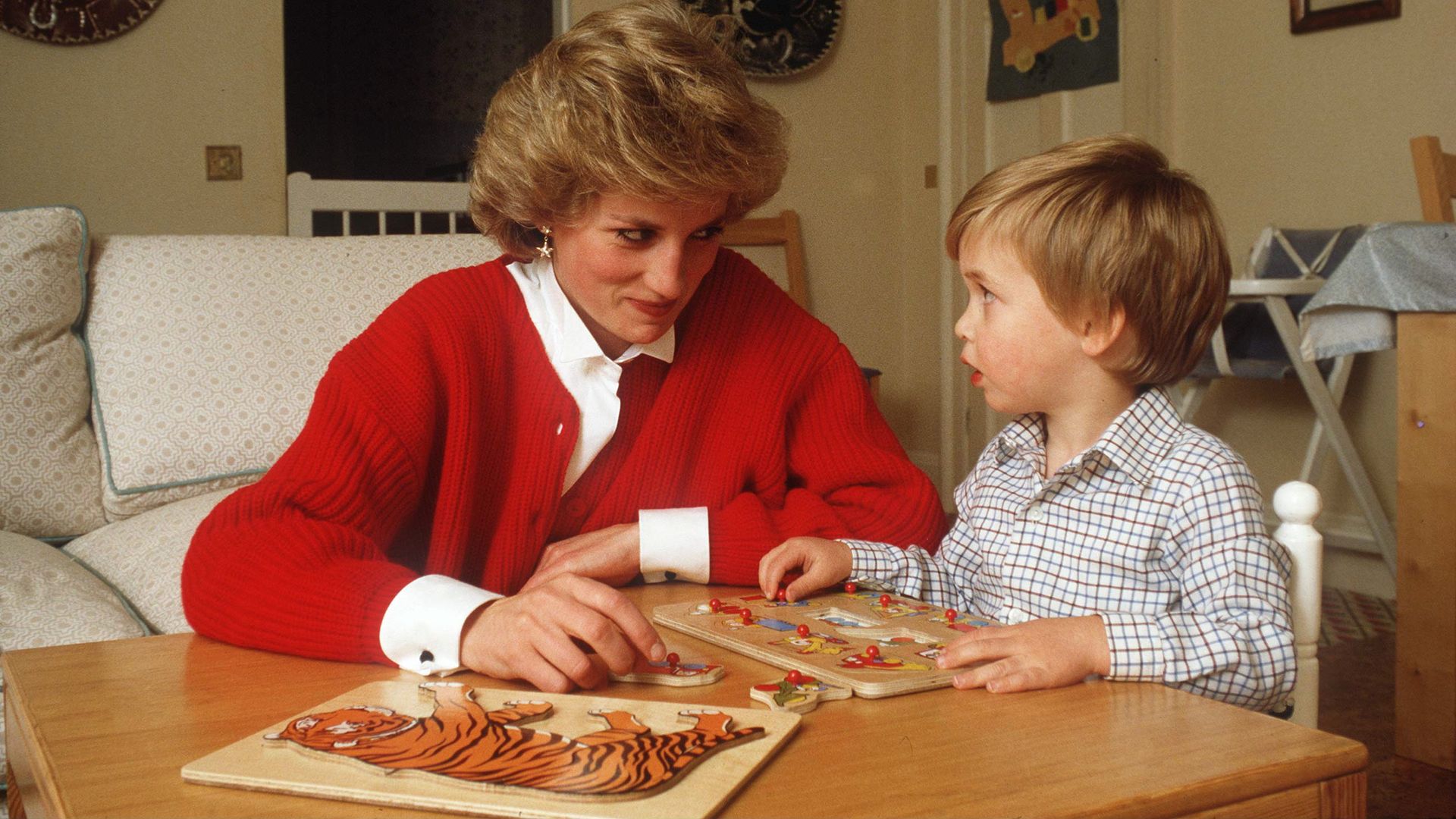 Diana helping William with a puzzle at home
