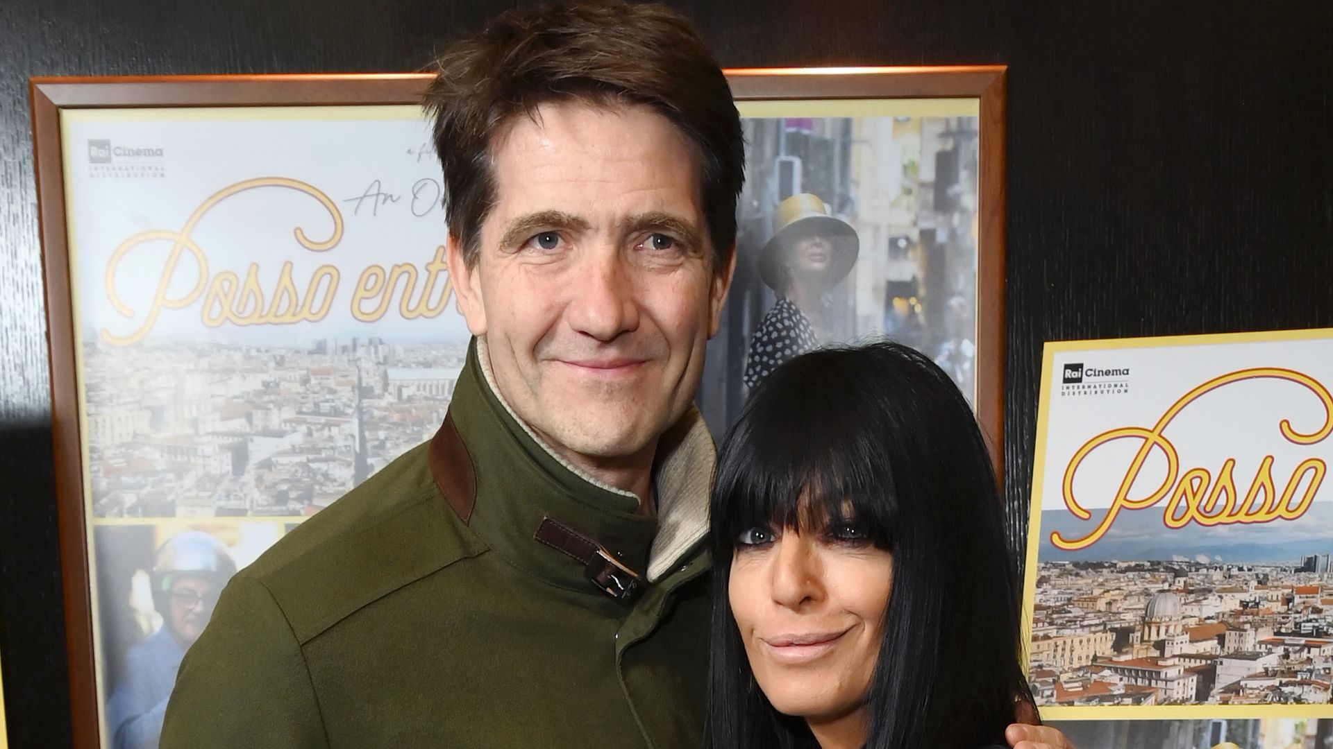 Kris Thykier in a green jacket with his arm around Claudia Winkleman in a black outfit