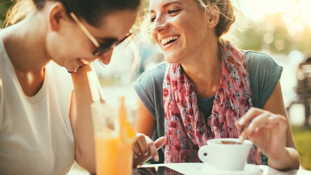 Female friends talking in cafe