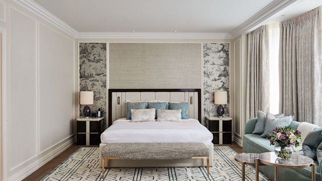 Landmark London's Signature Suite bedroom with king size bed and blue-accent furnishings