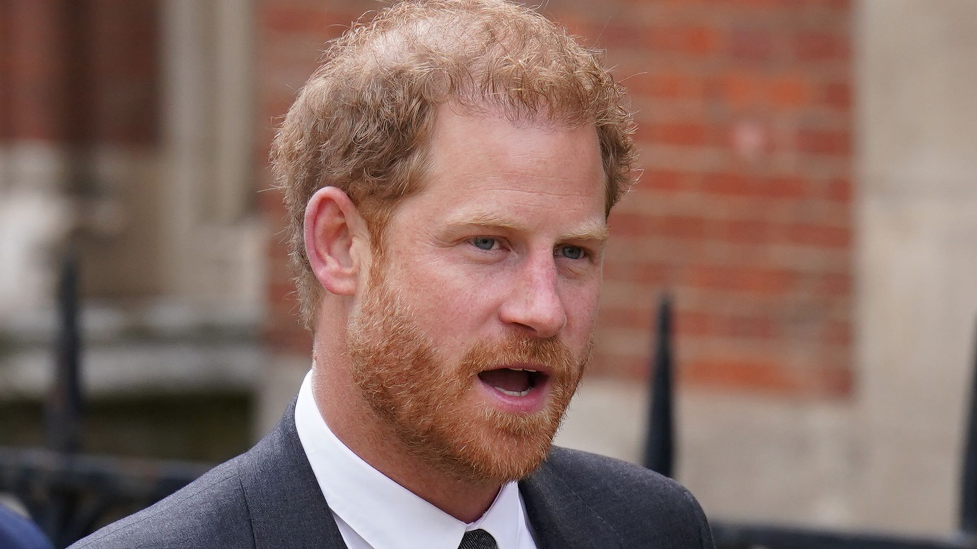 Prince Harry looking serious in a suit