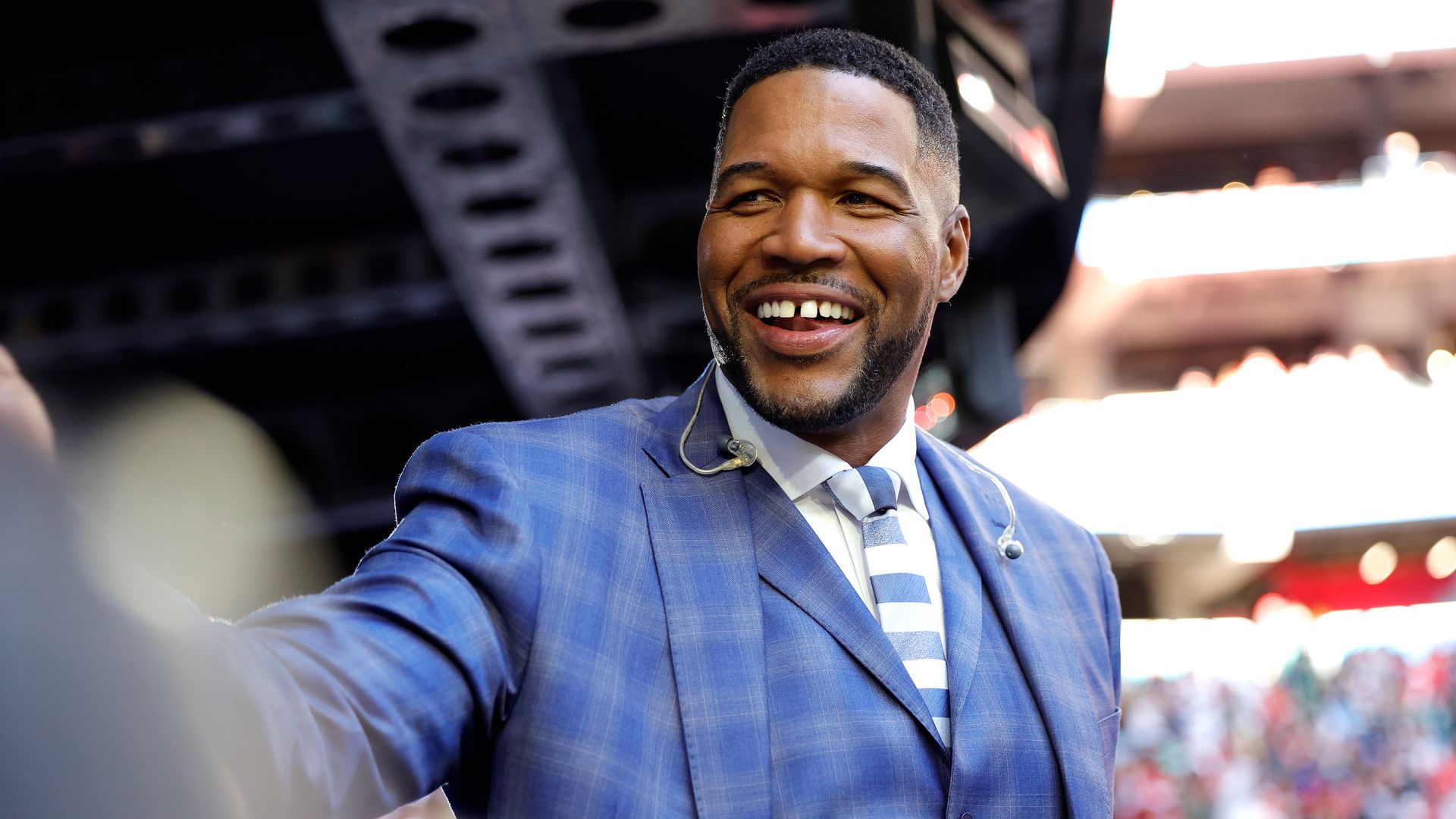 Michael smiling in the crowds before Super Bowl with head piece