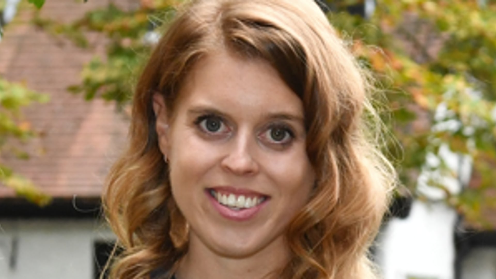 beatrice and eugenie pose in floral dresses outside