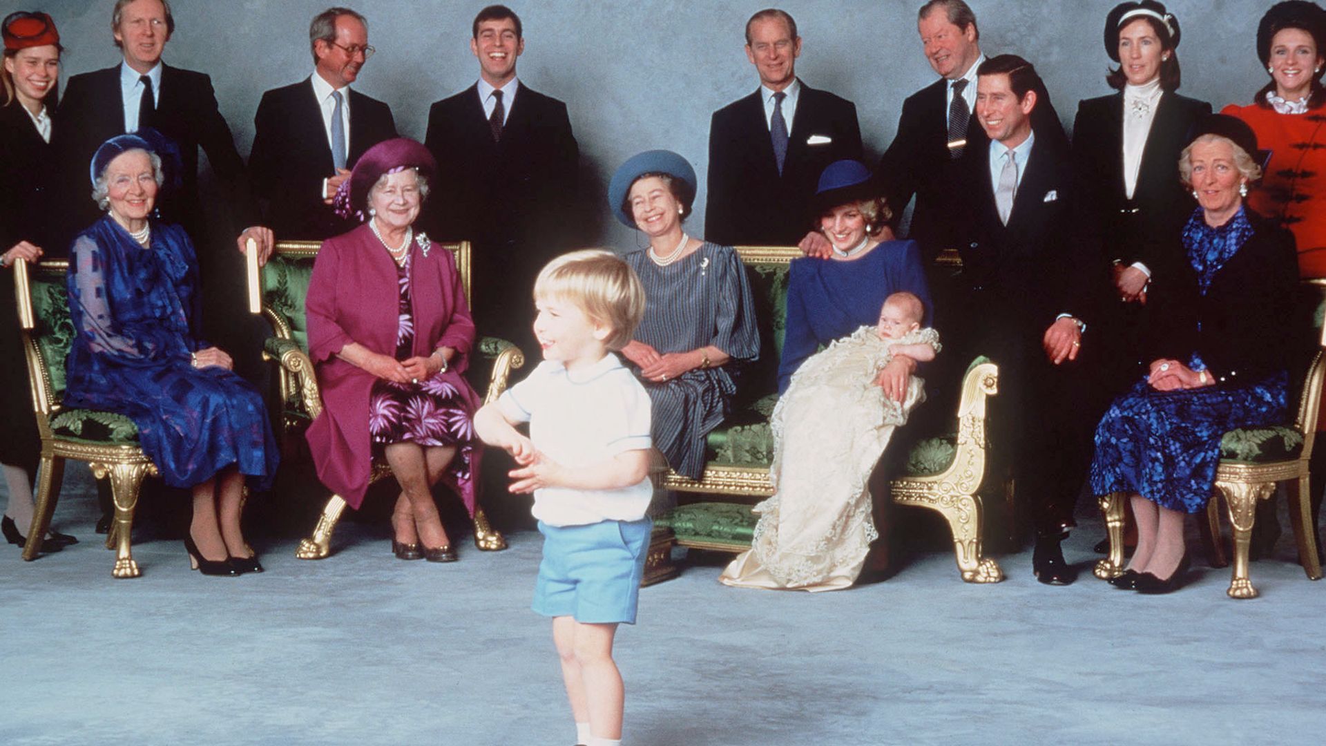 A young Prince William in the centre of the room surrounded by other members of the royal family