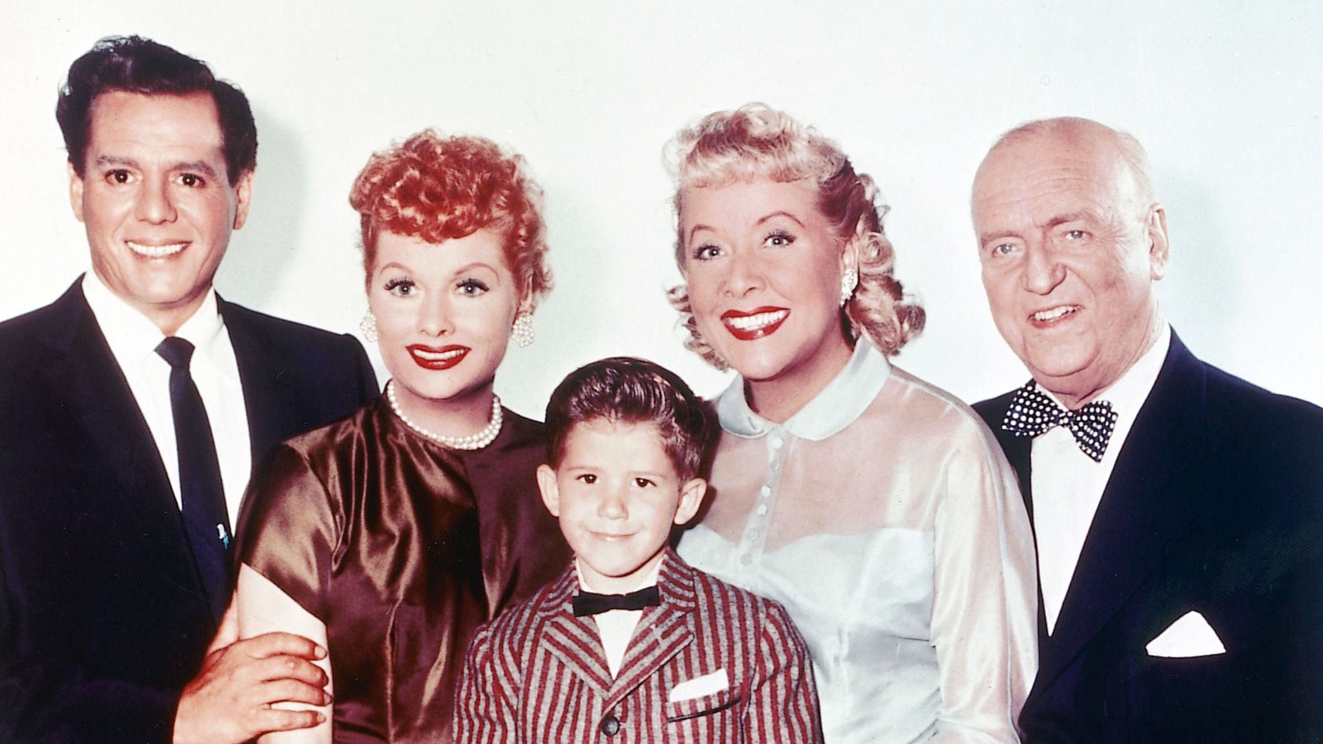 Desi Arnaz (1917-1986), Cuban musician and actor, Lucille Ball (1911-1989), US comedian and actress, Keith Thibodeaux, US child actor, Vivian Vance (1909-1979), US actress, William Frawley (1887-1966), US actor, in a group studio portrait, against a white background, issued for the US television series, 'I Love Lucy', USA, circa 1955