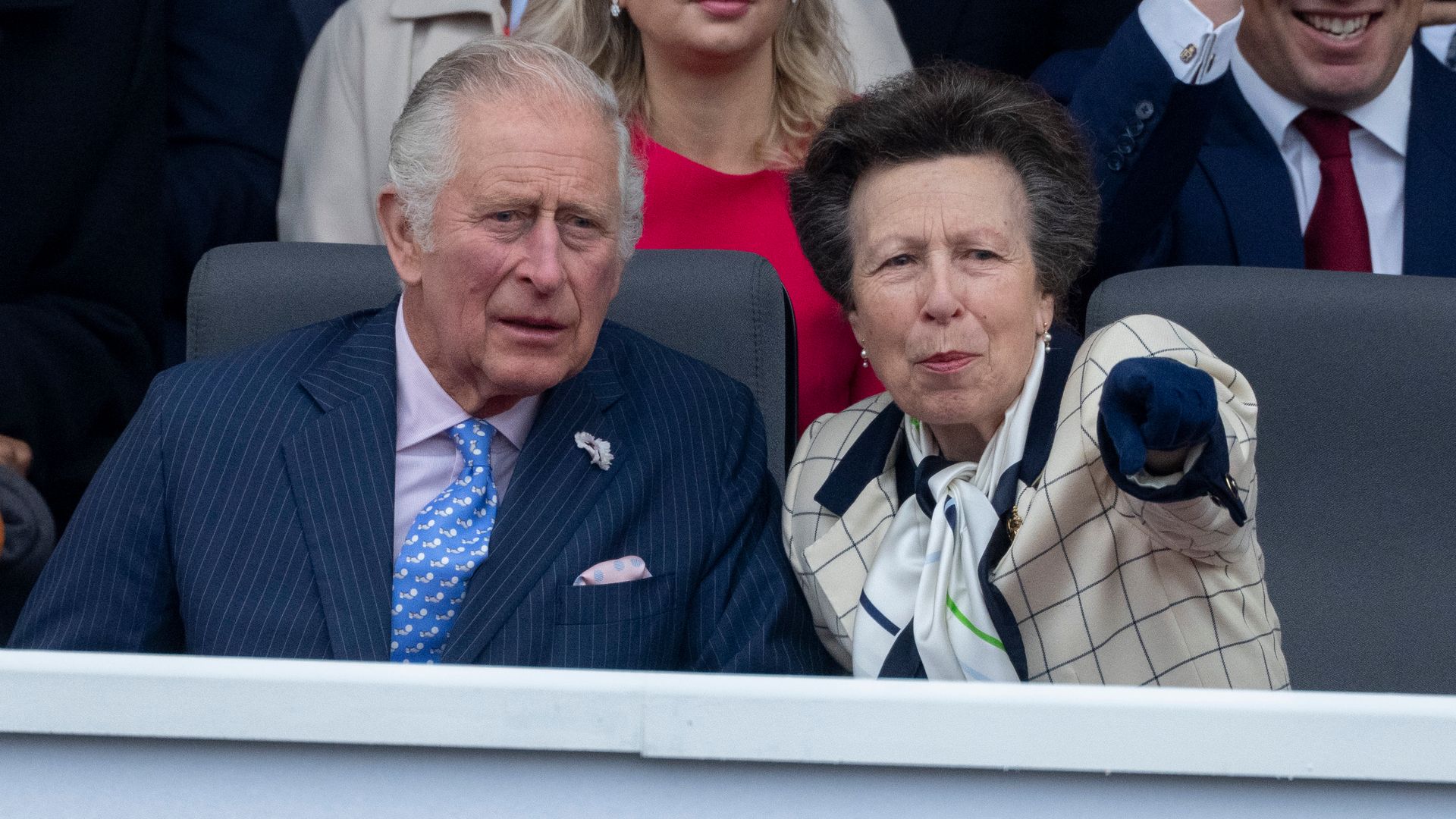 Princess Anne pointing something out to King Charles
