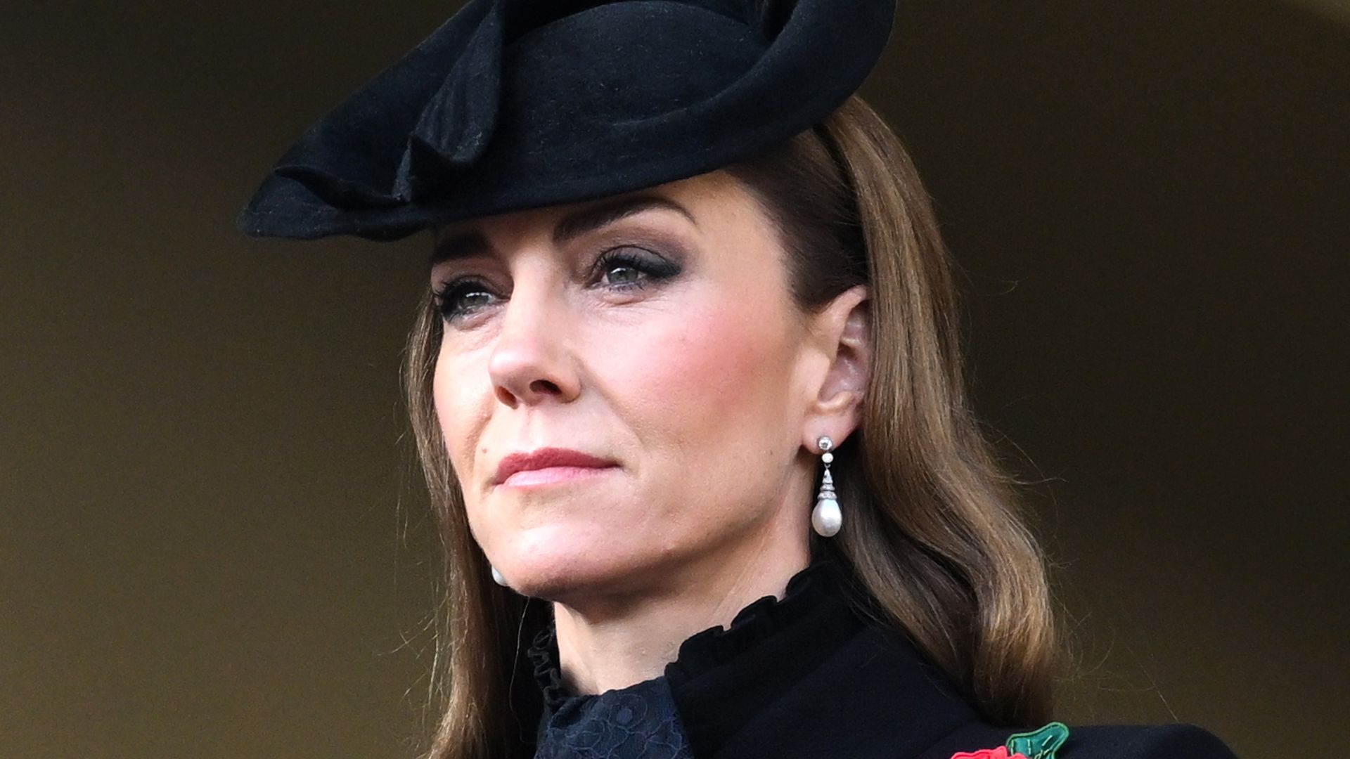 Catherine, Princess of Wales looking serious in black coat and hat