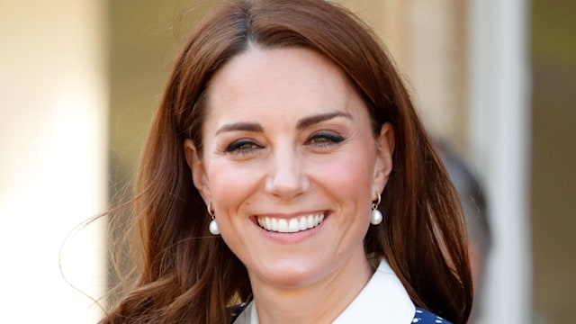 kate middleton smiling in navy and white polka dot dress