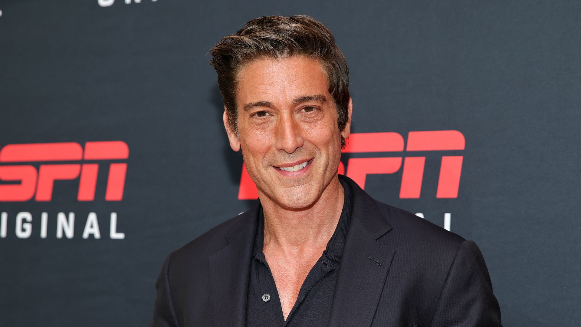 David attended the ESPN event solo smiling 