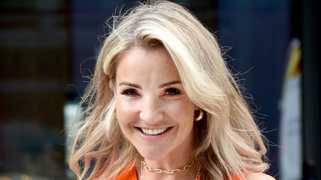 Helen Skelton smiling in orange top