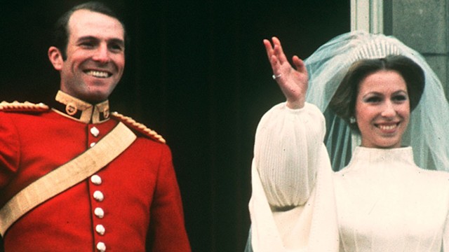 Princess Anne and Captain Mark Phillips waving on the balcony of Buckingham Palace on their wedding day.   