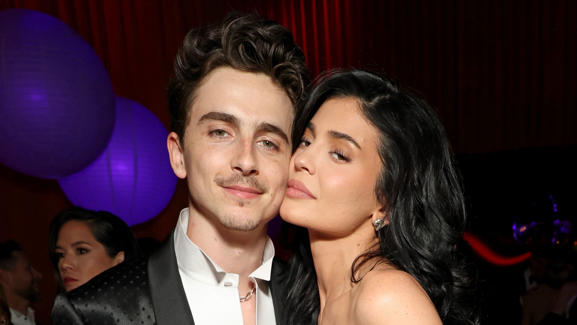 kylie jenner pressing face against timothee chalamet cheek posing for photo