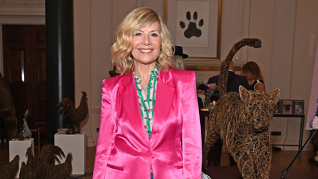 Glynis Barber in jeans and a pink jacket