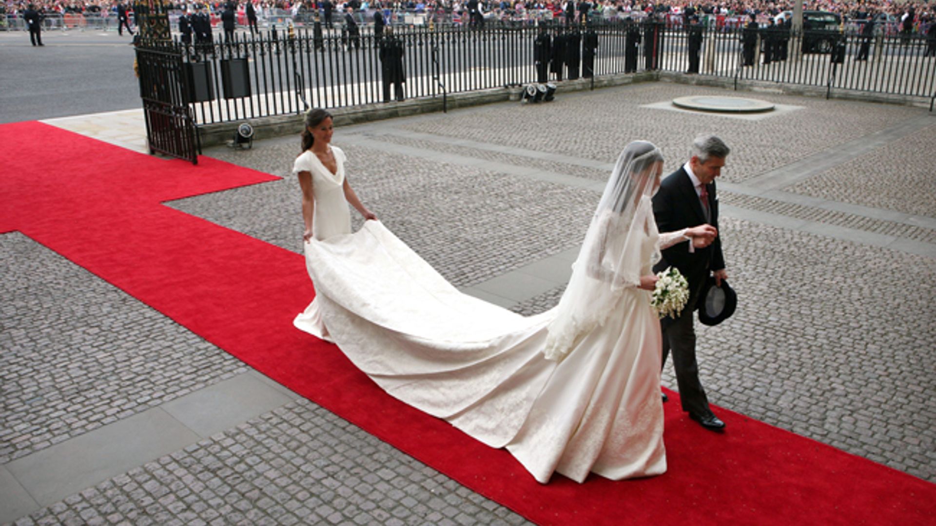Pippa Middleton holding her sister Princess Kate's bridal train ahead of her wedding