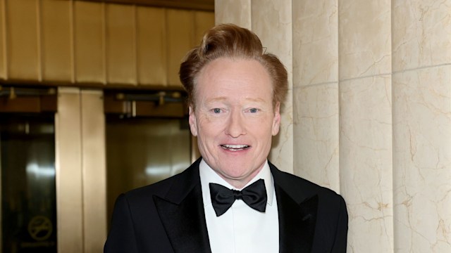 conan obrien smiling in suit and bow tie
