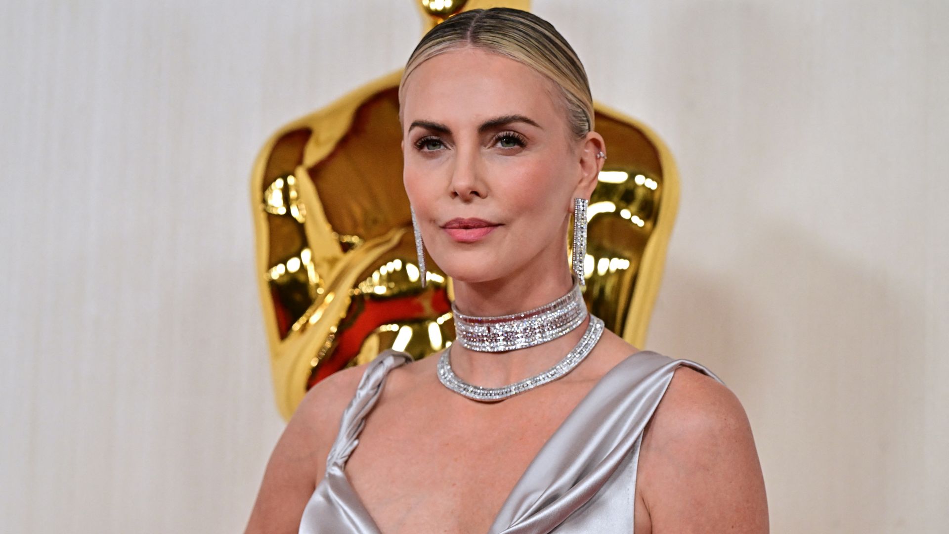 Charlize Theron is a goddess in pink silk Dior gown as she steps out on