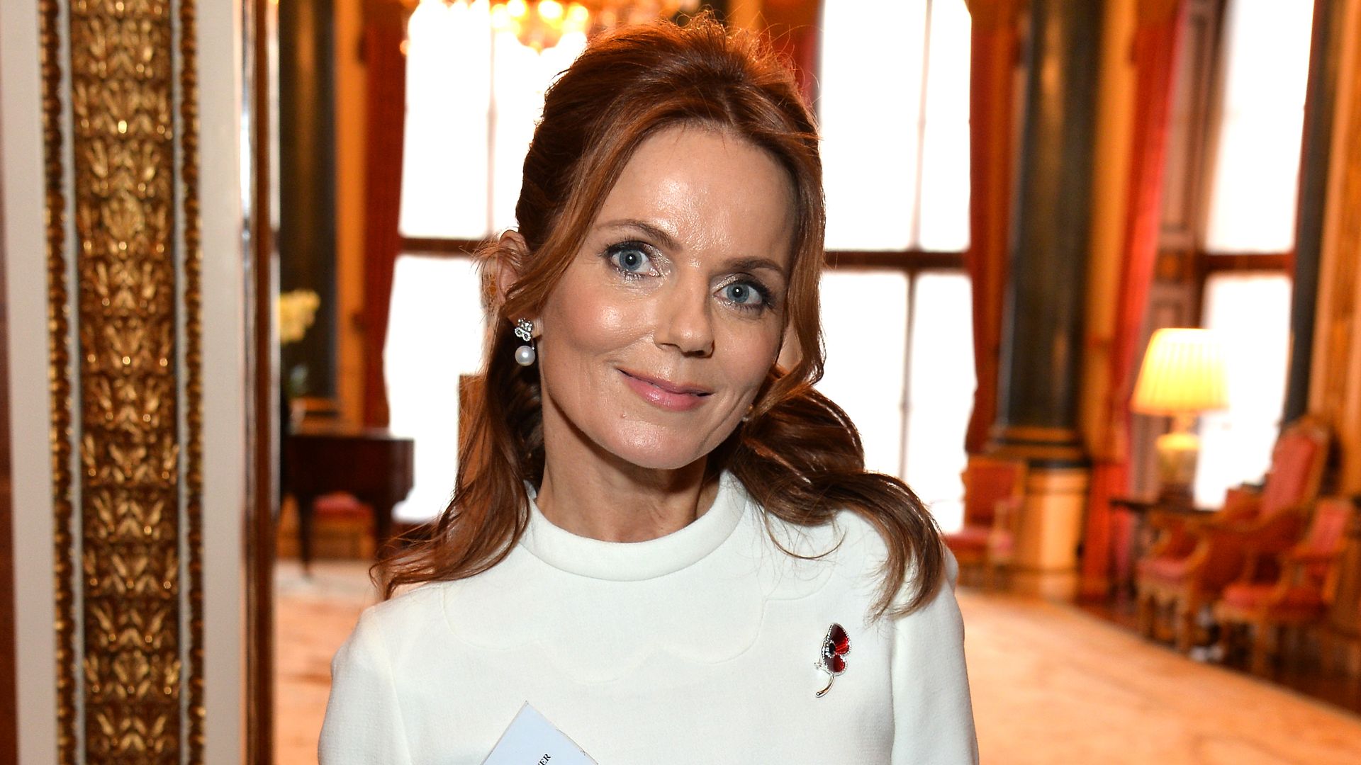 Geri Horner in a white dress with a rose lapel