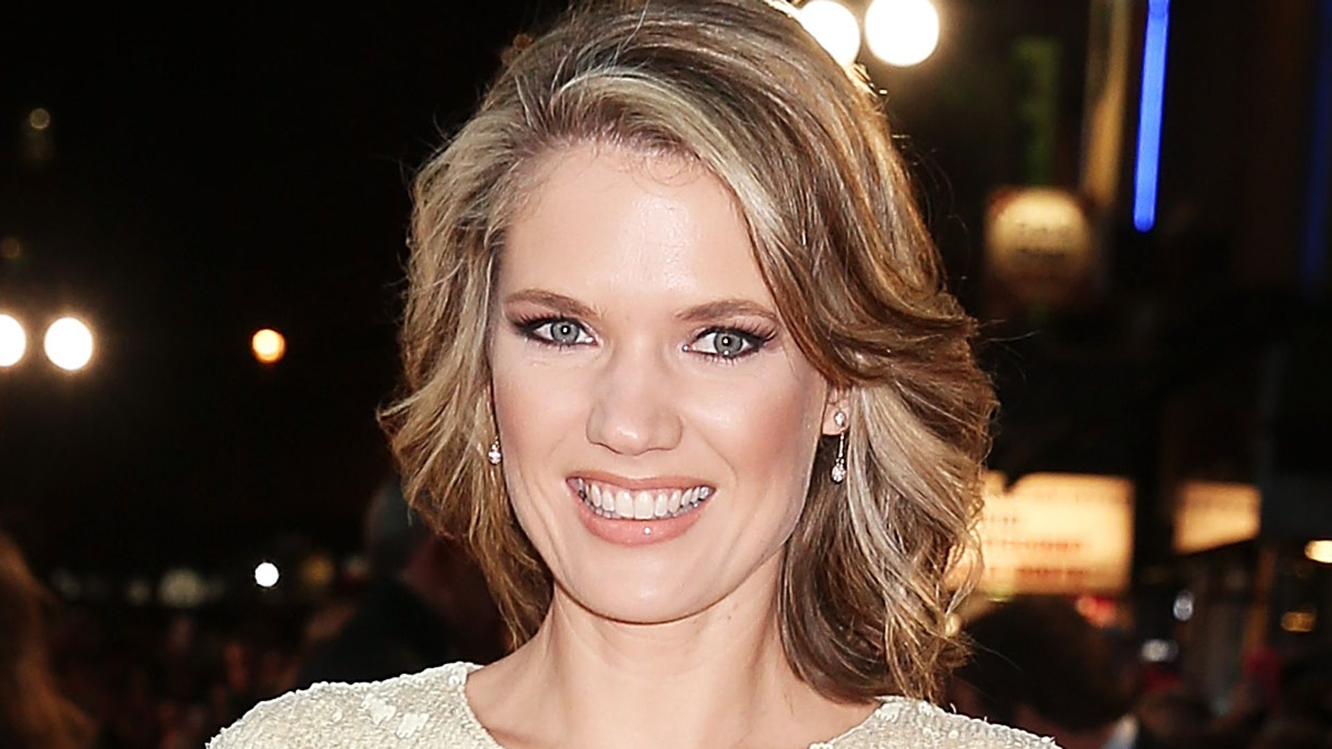 Charlotte Hawkins in a white and black dress with curled hair