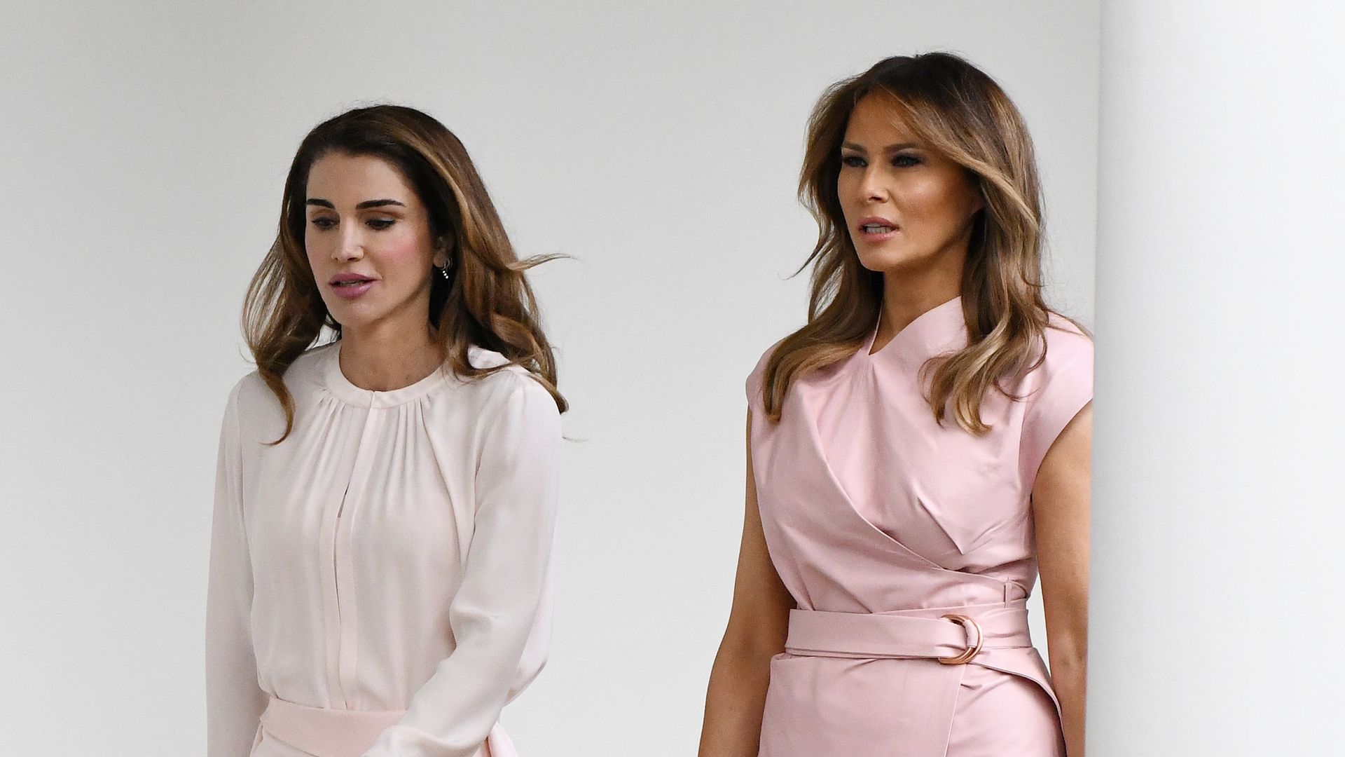 Melania Trump and Queen Rania of Jordan walk the colonnade of the White House