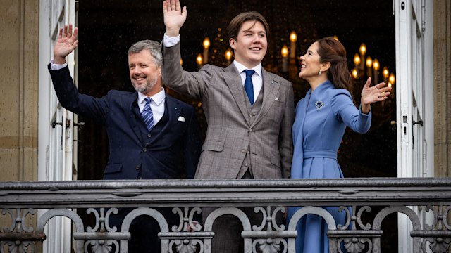 Queen Mary, King Frederik and Prince Christian waving from palace balcony