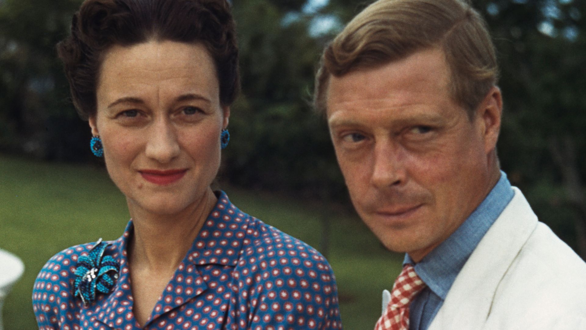 Wallis Simpson in a blue dress and the Duke of Windsor sitting outside