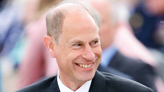 Prince Edward wearing medals and smiling