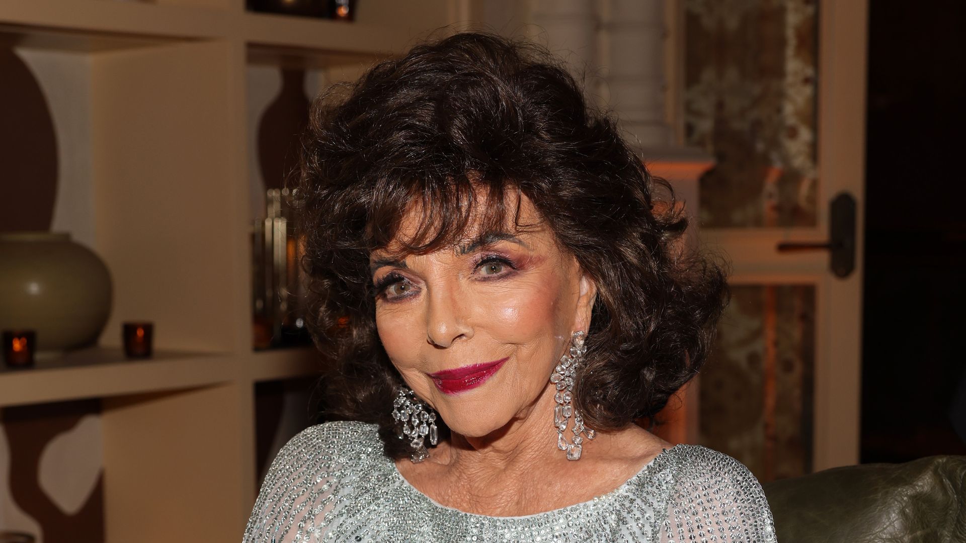 Joan Collins is the ultimate vixen in daring thigh-high split dress