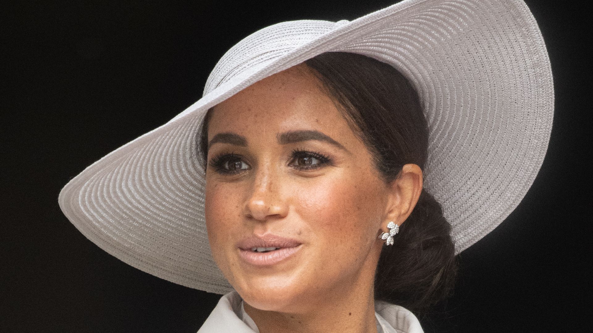 Meghan Markle in a white outfit and hat