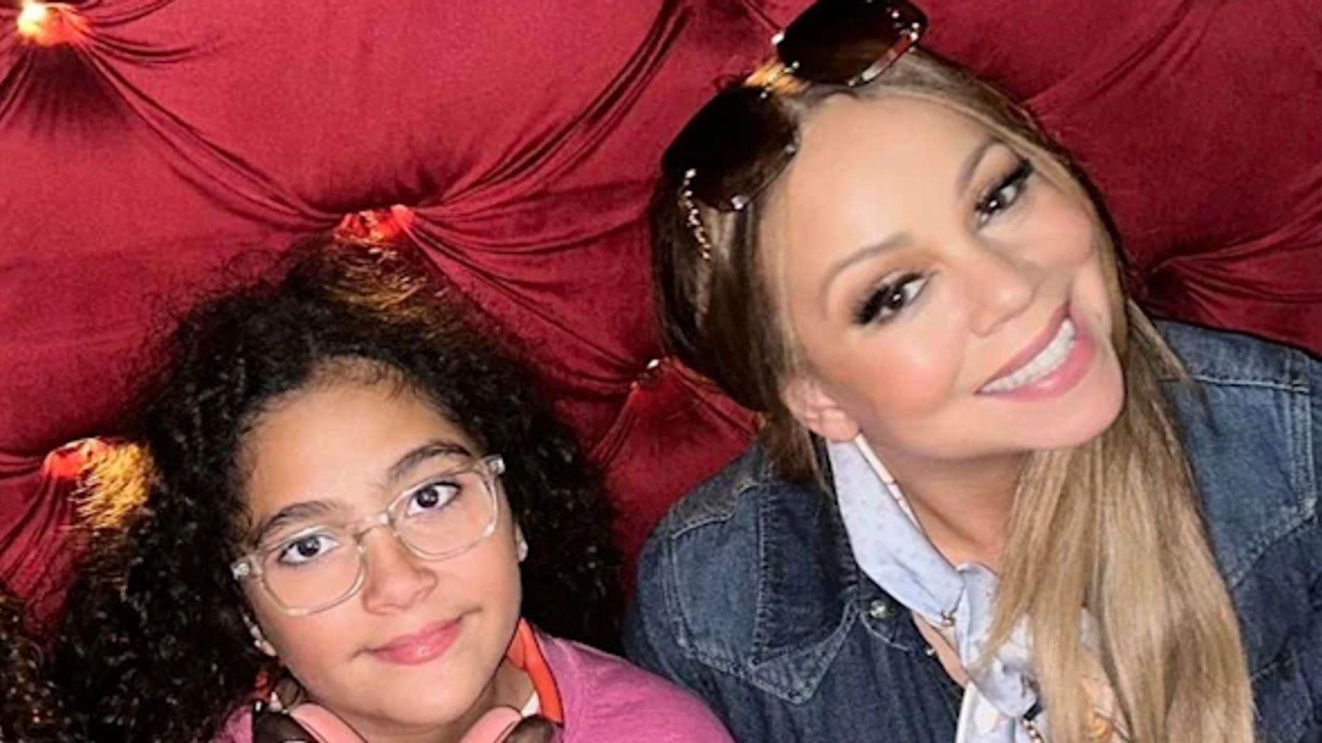 mariah carey kids moroccan monroe sitting on red couch
