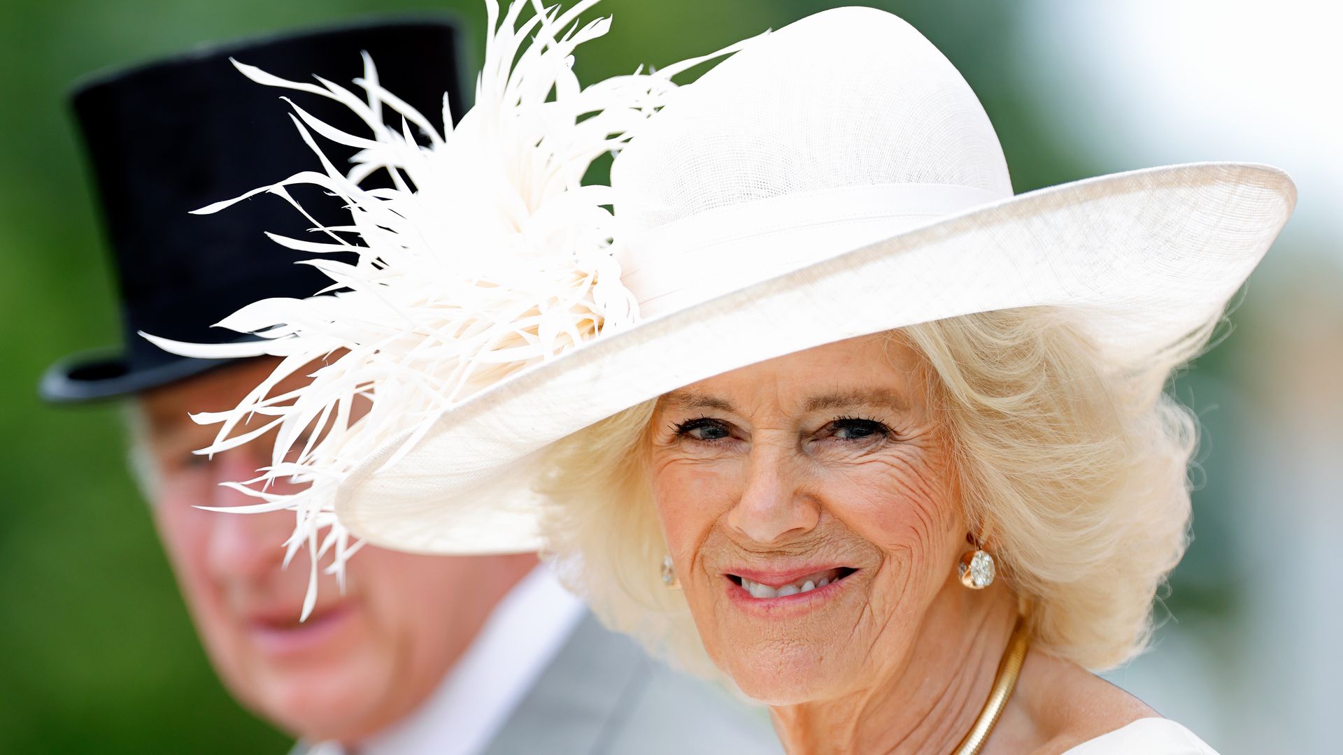 King Charles III and Queen Camilla in white hat
