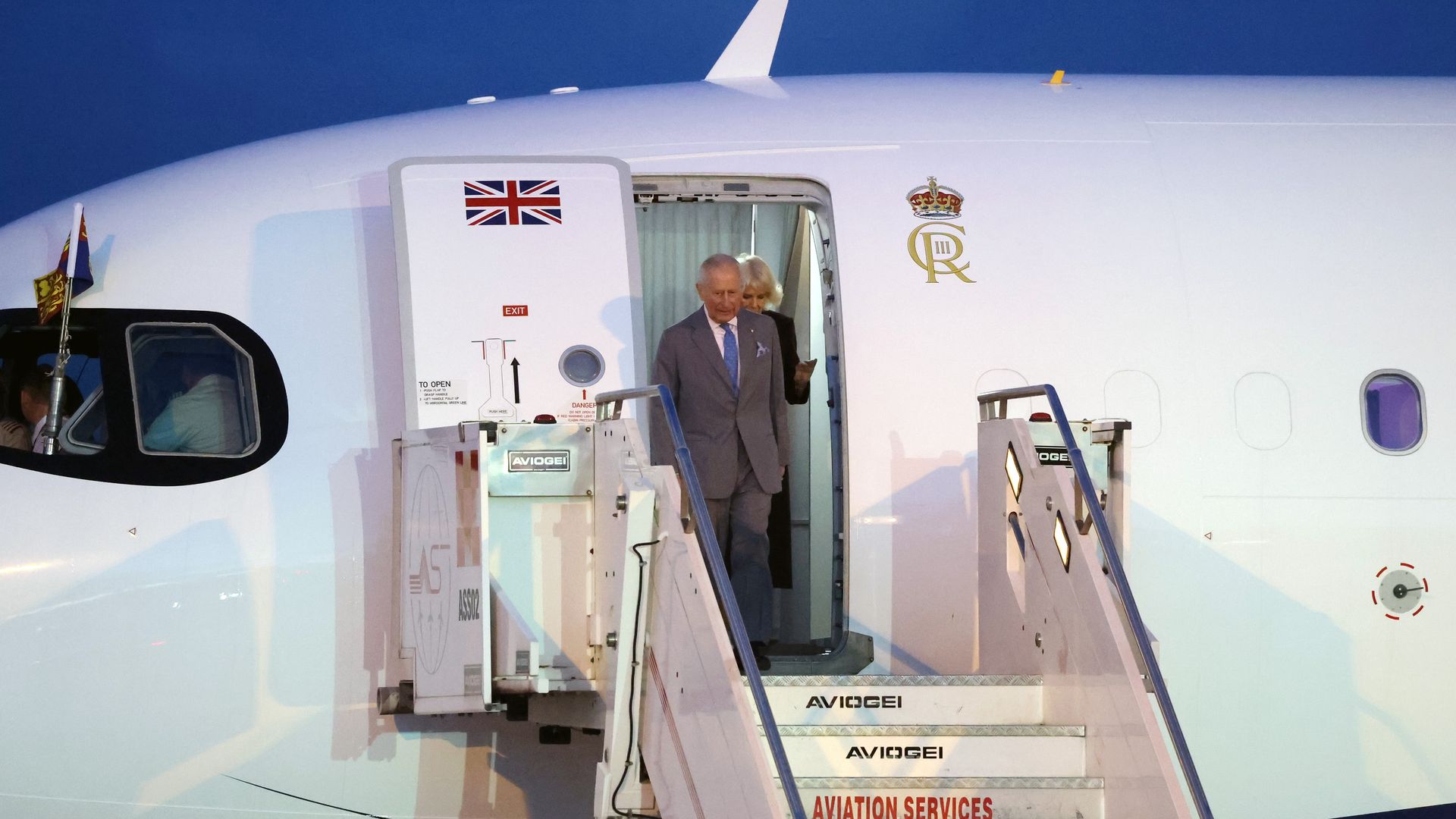 King Charles and Queen Camilla disembarking a plane
