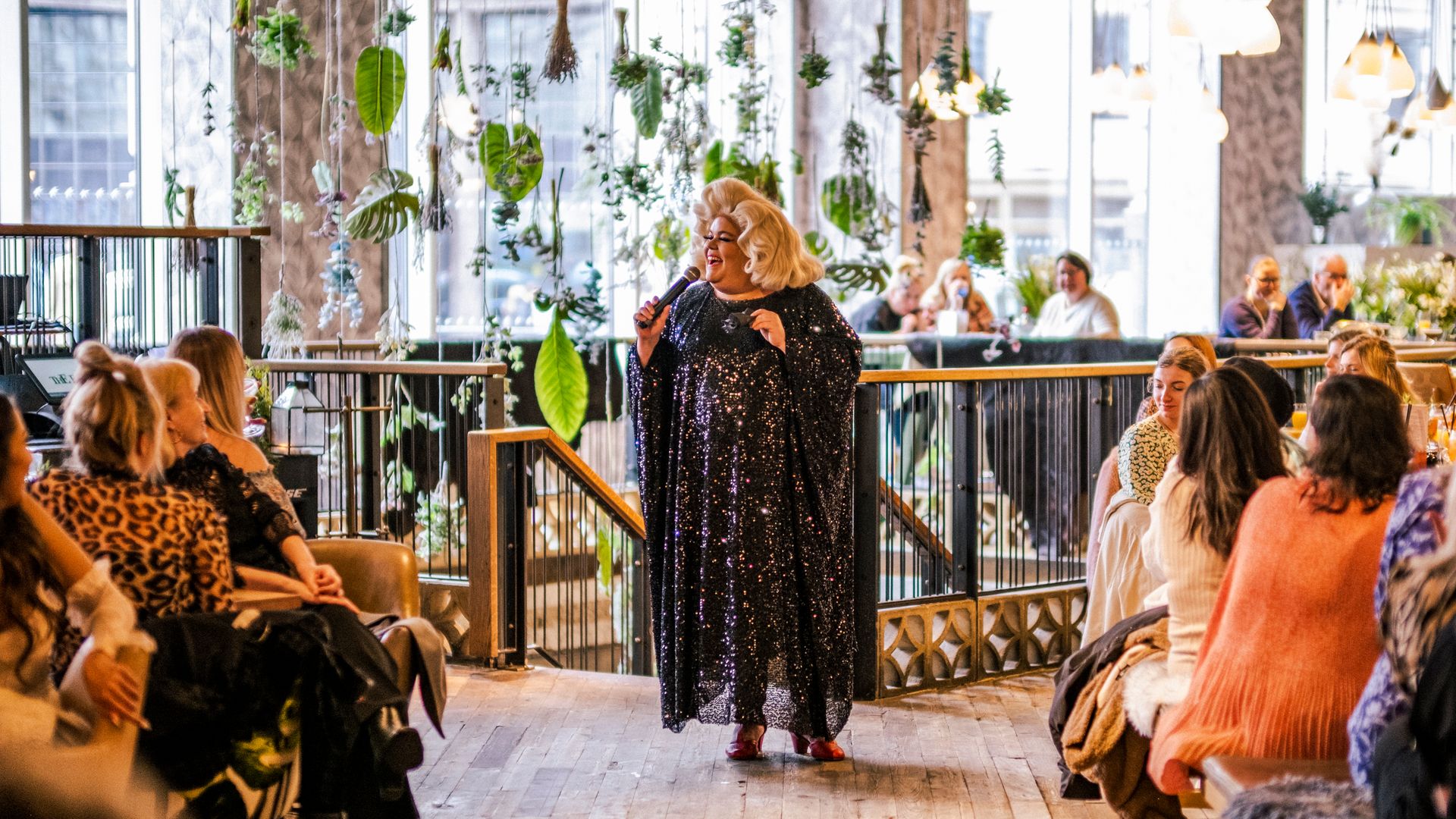 A drag queen performing inside a building