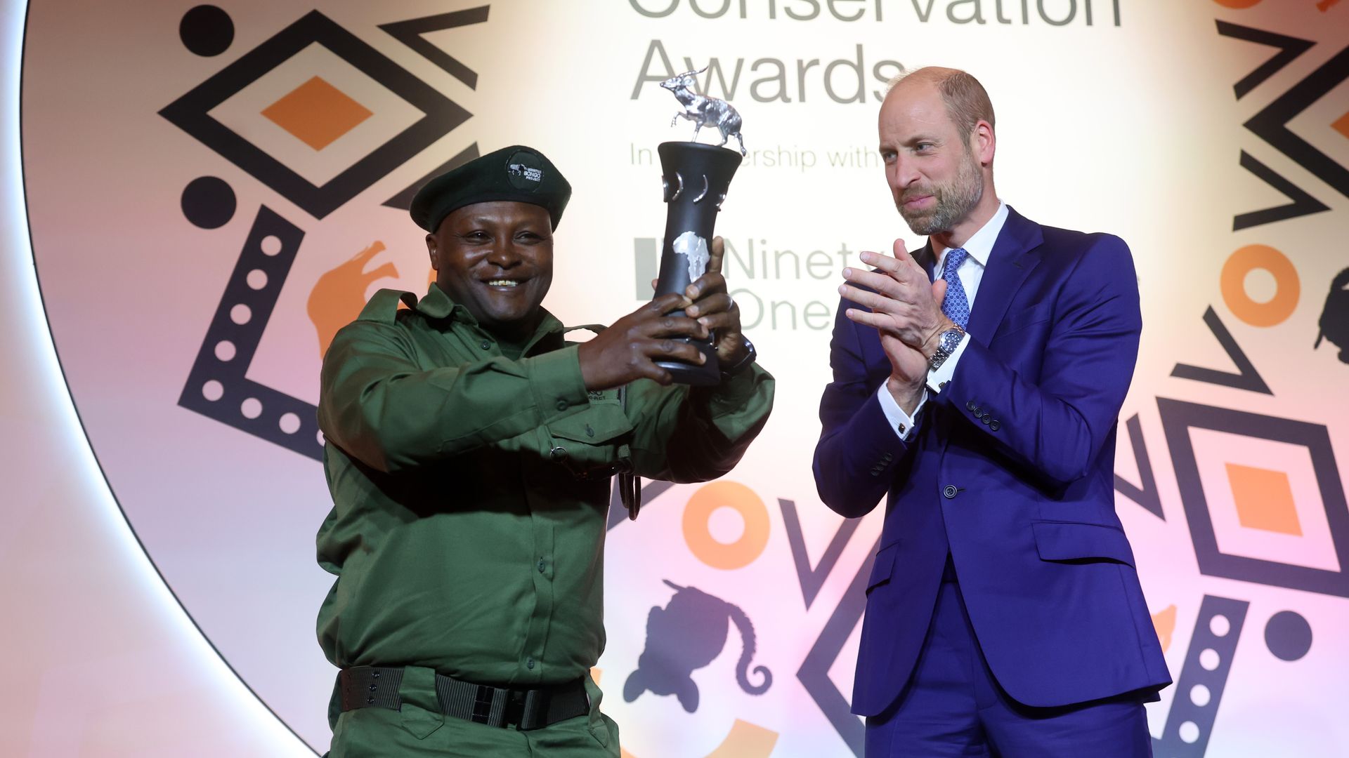 Prince William applauding as he delivers an award