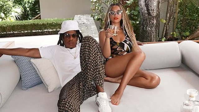 Beyonce and Jay Z sitting on a sun lounger at private villa while on vacation