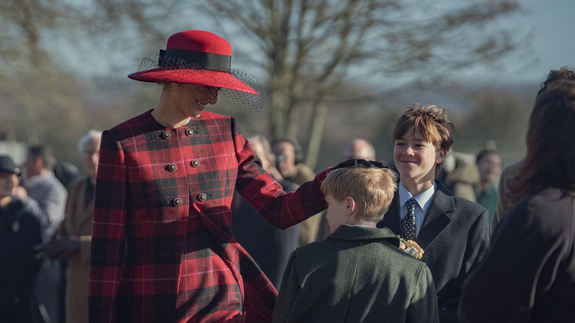Elizabeth Debicki as Princess Diana in red tartan ensemble 