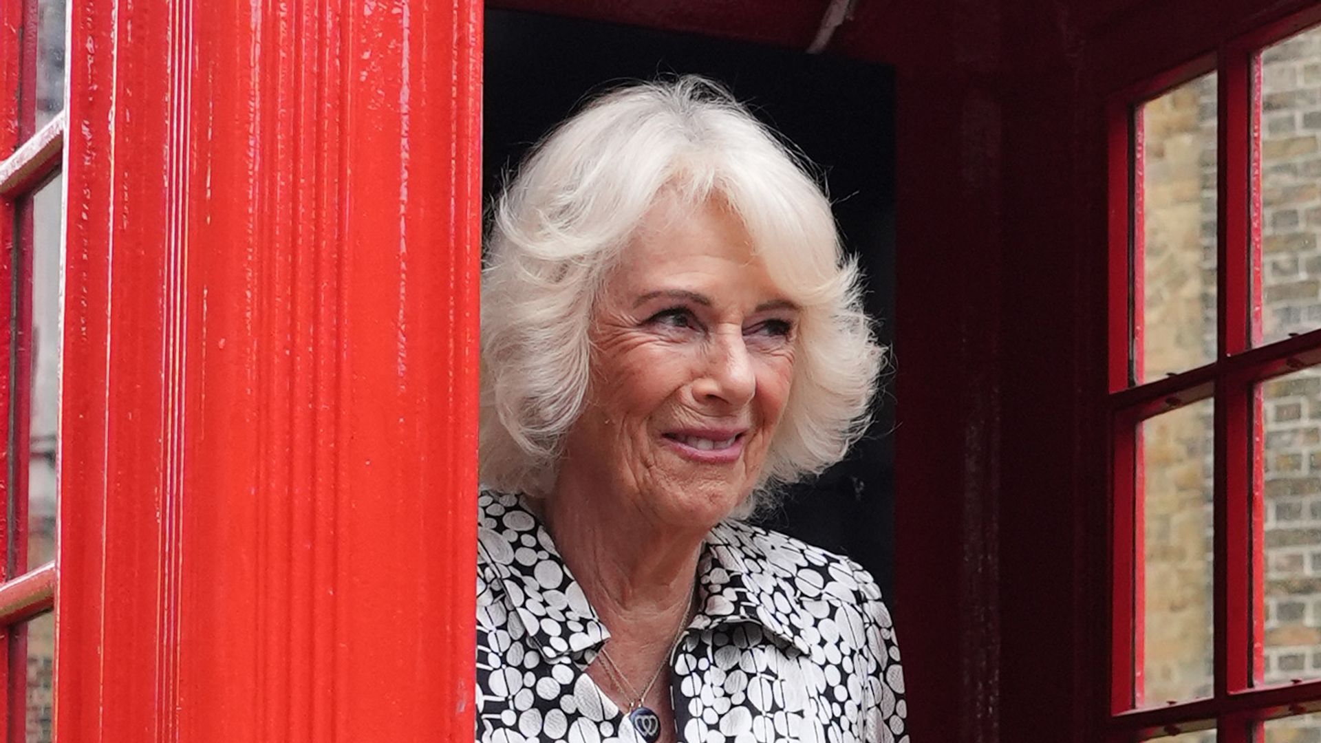 Queen Camilla joins eight pupils from Dulwich Village Infants' School inside the original telephone box during her visit to Dulwich Picture Gallery on September 4, 2025 in London, England. (Photo by Jonathan Brady-WPA Pool/Getty Images)