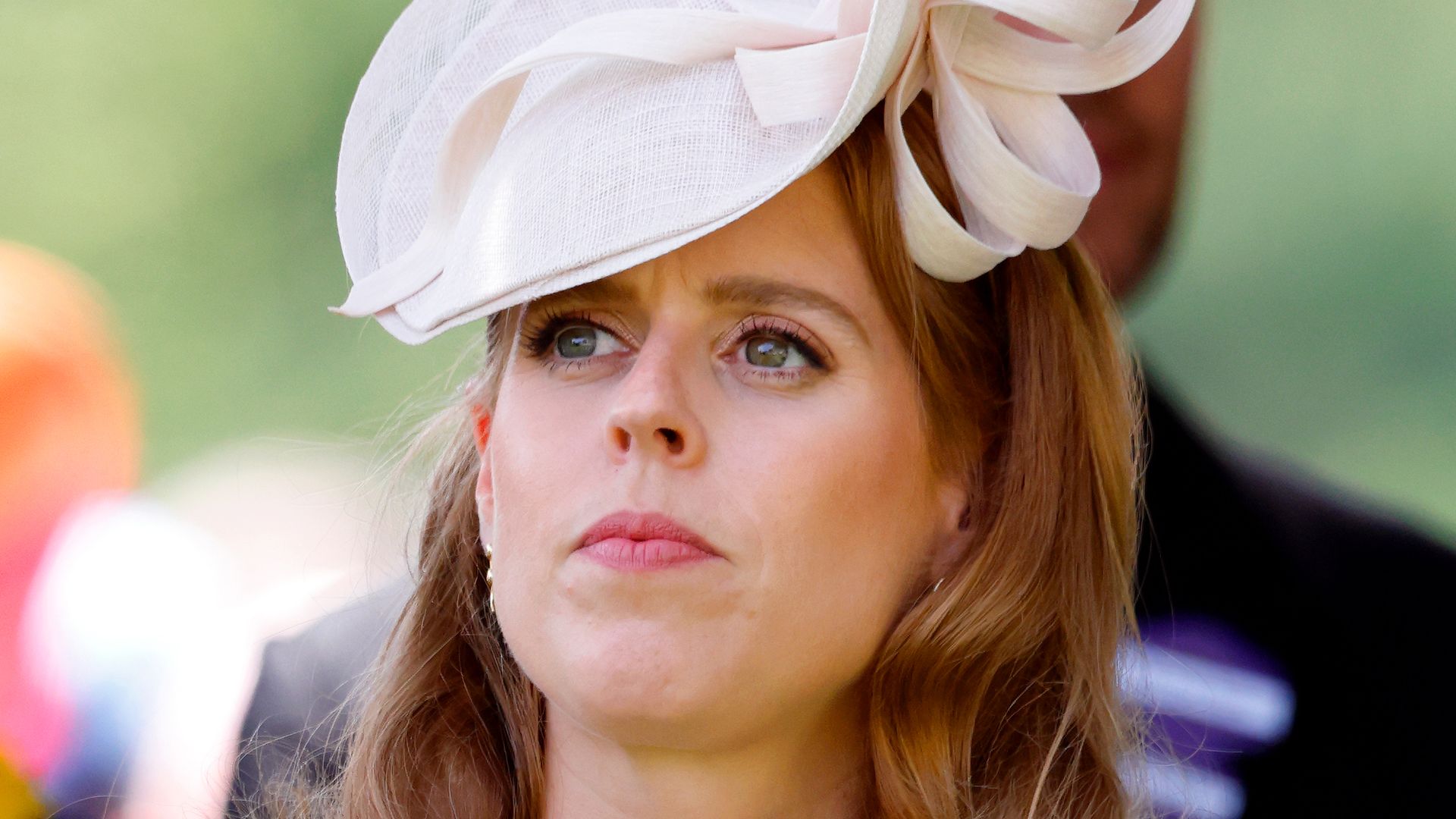 Princess Beatrice looking up in gingham dress and cream hat