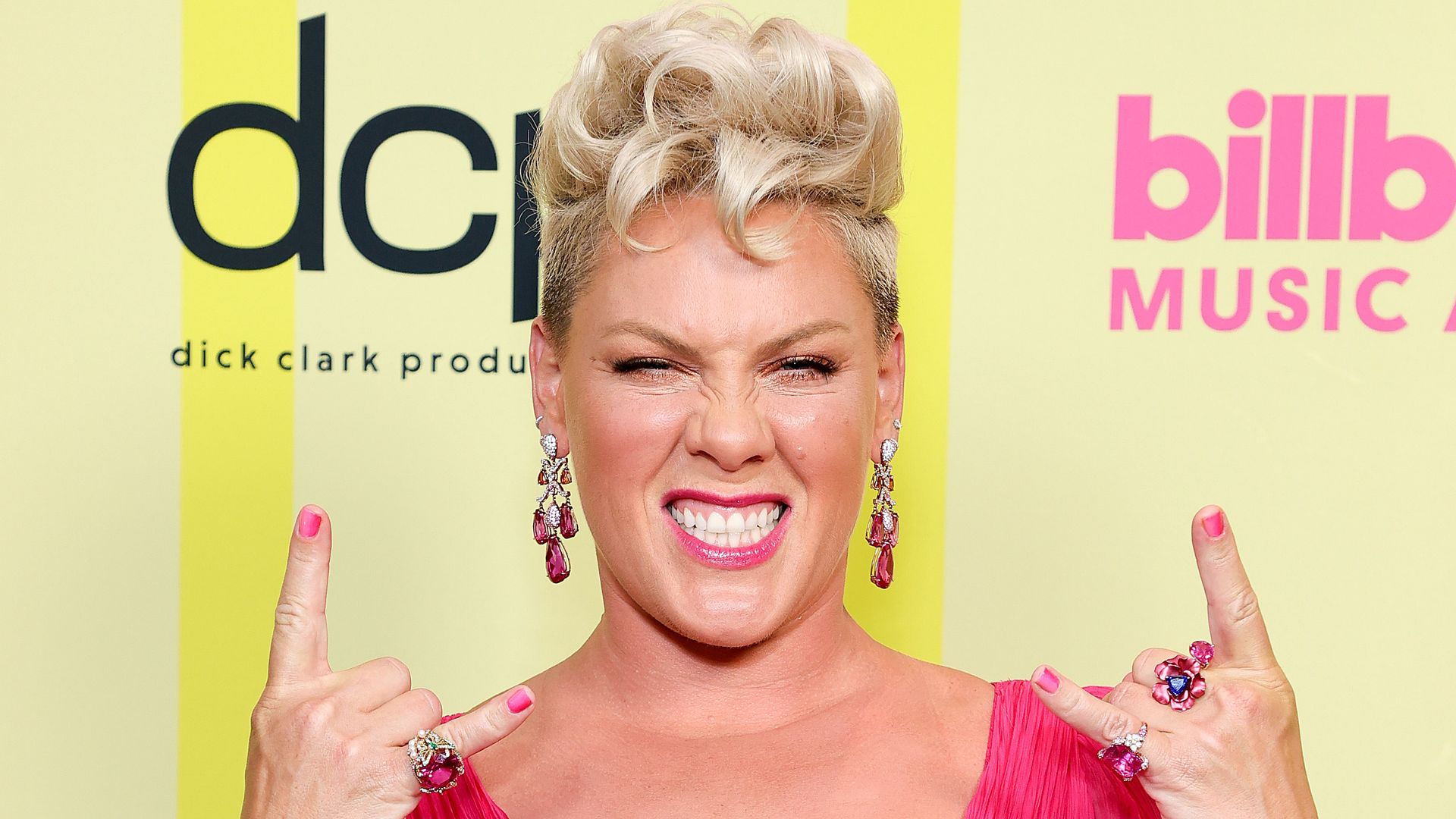 pink throwing up rock signs