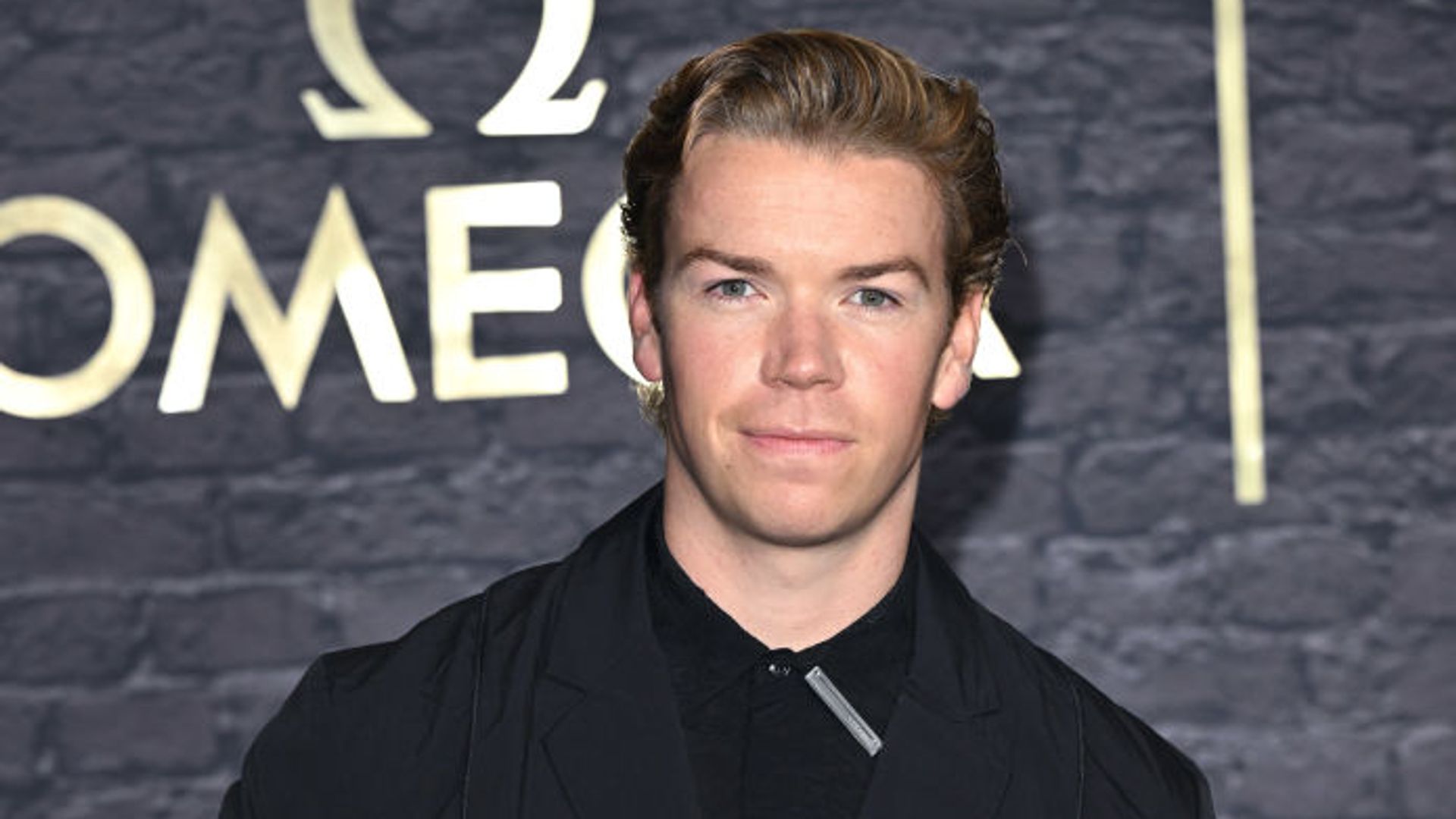 Will Poulter wears a black suit as he attends a photocall for "60 Years of James Bond" on November 23, 2022
