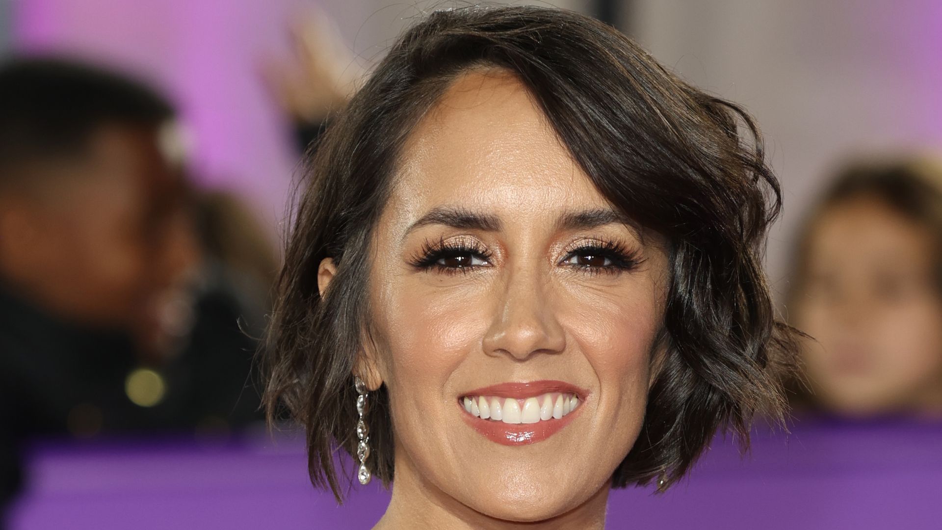 Janette Manrara smiling in strapless white dress