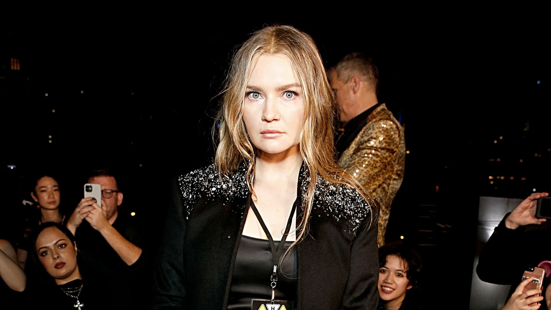 Anna Delvey wearing an embellished jacket over polished black separates 