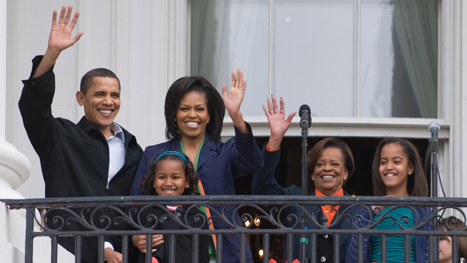 US President Barack Obama waves alongside First Lady Michelle Obama, their daughters Sasha(R) and Malia and Marian Robinson (2nd R), Michelle's mother, during the annual White House Easter Egg Roll on the South Lawn of the White House in Washington, DC, on April 13, 2009. More than 30,000 guests will attend this year's events, which include a kids kitchen, an organic kitchen, live musical performances, kids yoga and the traditional Easter egg roll.